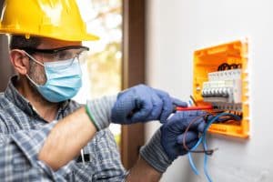 Electrician at work on an electrical panel
